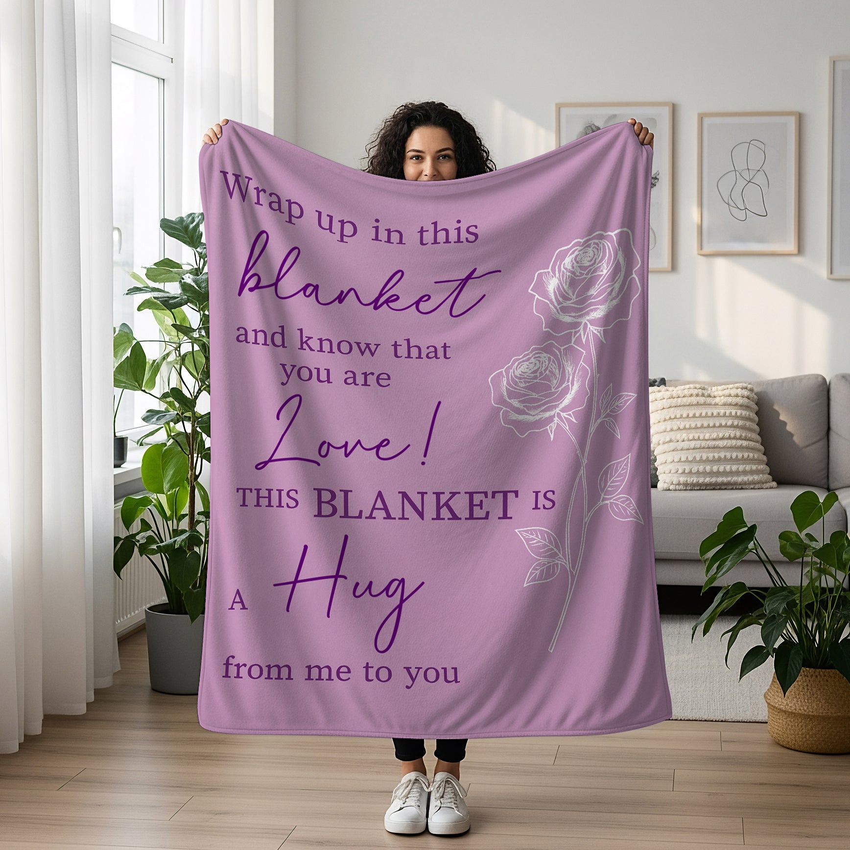 Woman holding a lavender blanket with rose design and the quote “This blanket is a hug from me to you,” symbolizing heartfelt personalized gifts — Discover meaningful personalized gifts at HerTender.com.