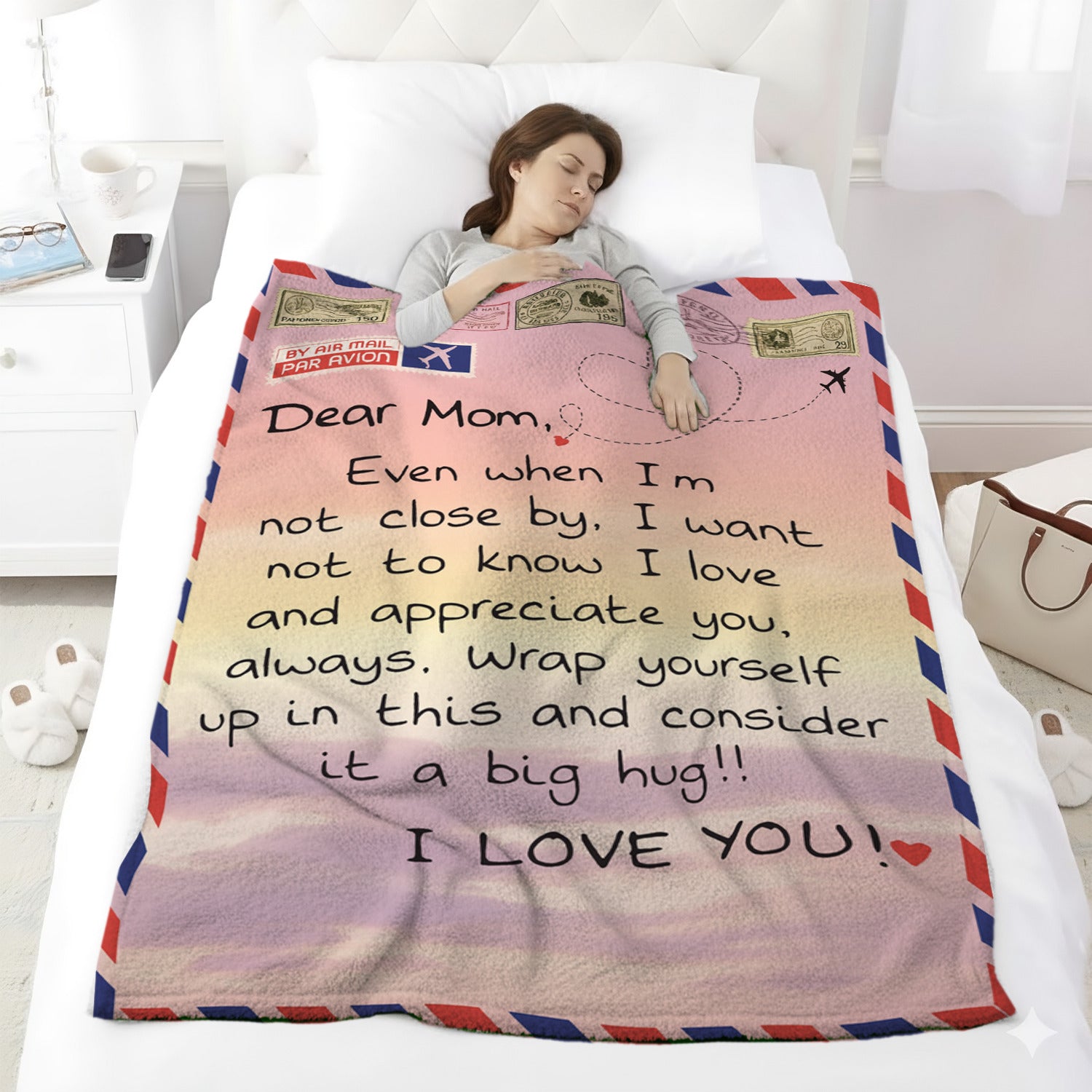Woman sleeping under an airmail-style mom blanket with a loving long-distance message — Discover heartfelt personal gifts at HerTender.com