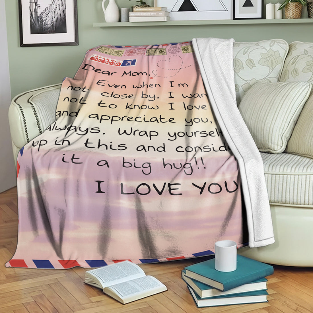 Airmail-style mom blanket with loving long-distance message draped over a cozy green sofa — Discover heartfelt personal gifts at HerTender.com