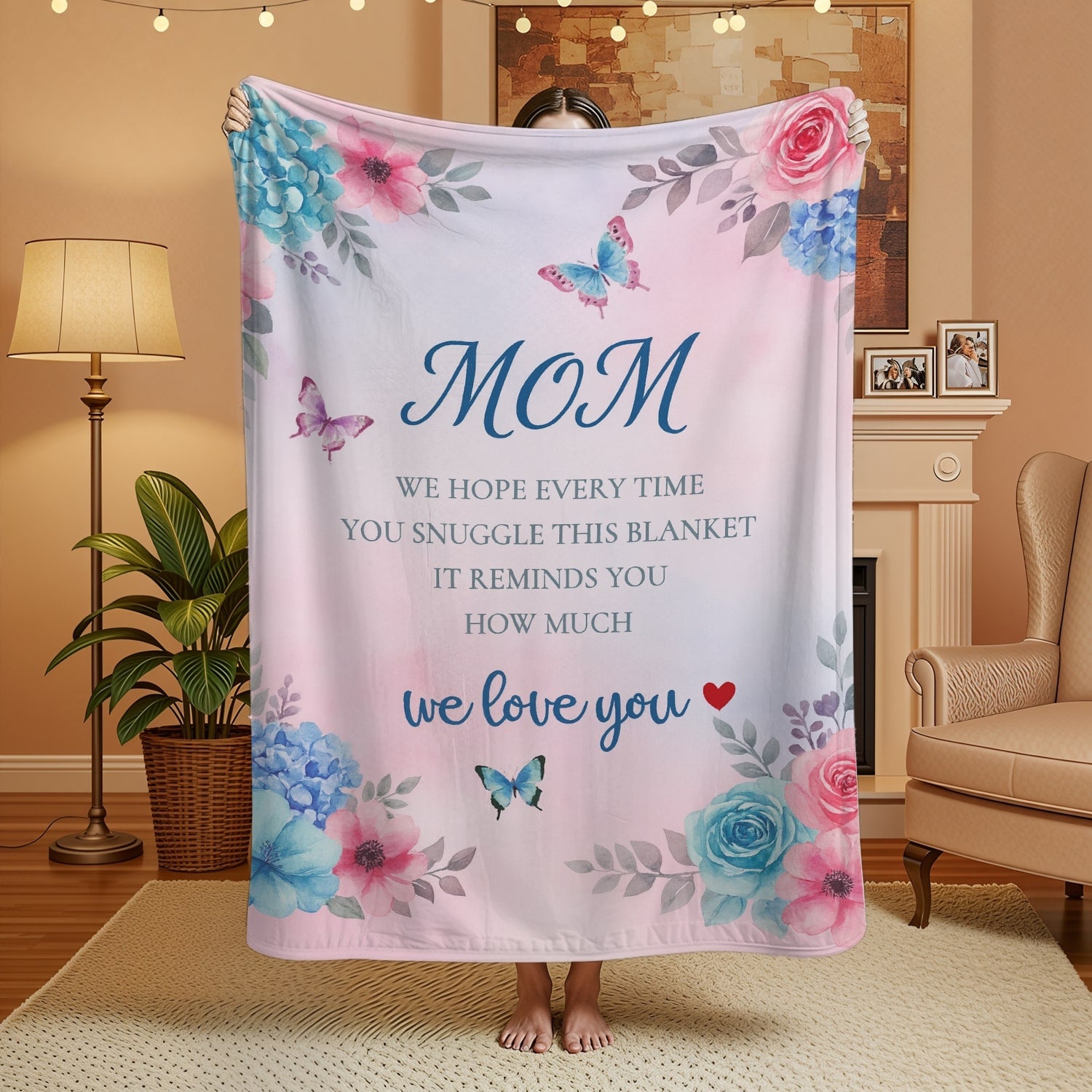 Pastel pink floral mom blanket with butterflies and loving message held in a cozy room — Discover heartfelt personal gifts at HerTender.com