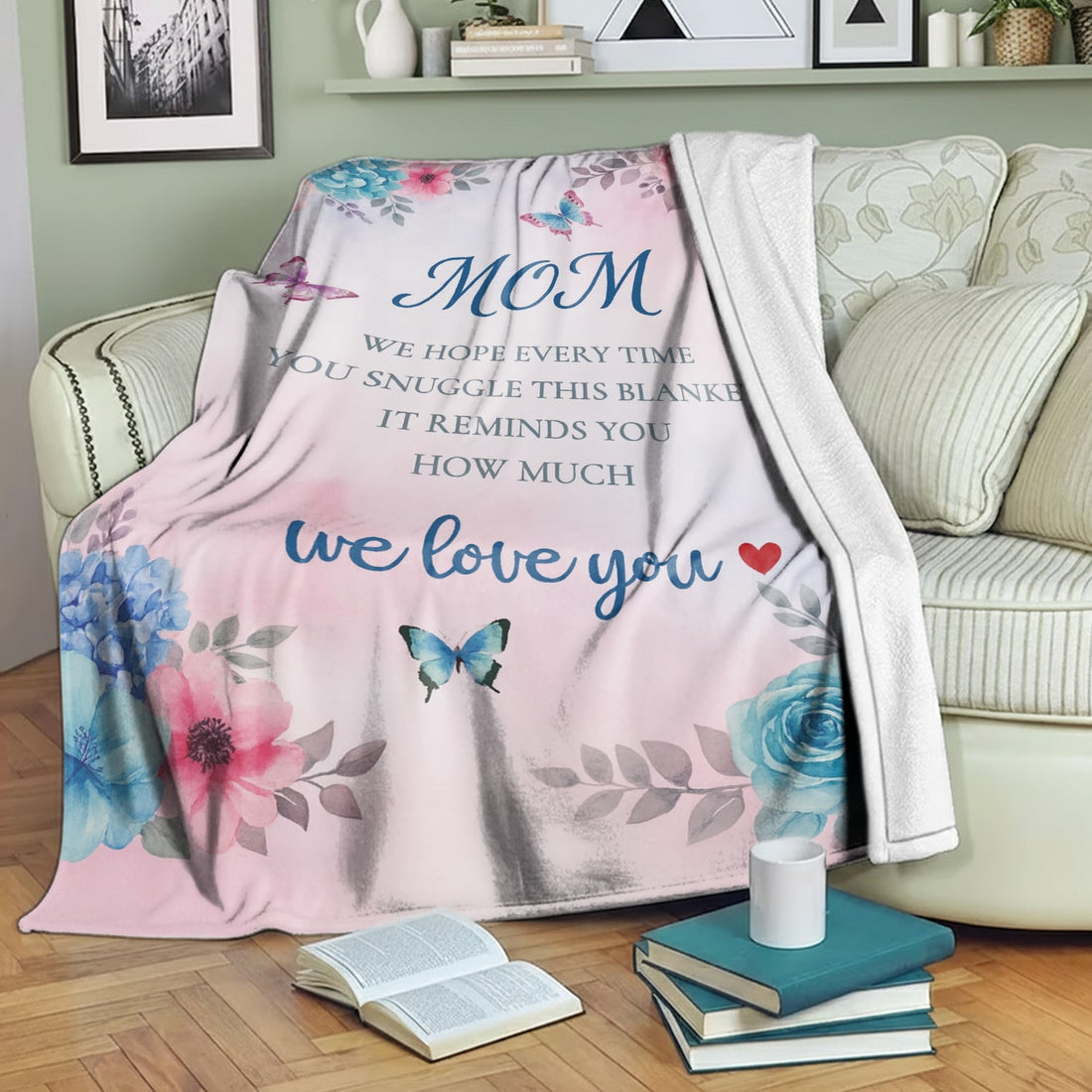 Pastel floral mom blanket with butterflies and loving message draped over a cozy sofa — Discover heartfelt personal gifts at HerTender.com