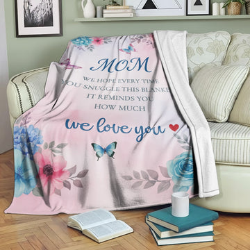 Pastel floral mom blanket with butterflies and loving message draped over a cozy sofa — Discover heartfelt personal gifts at HerTender.com