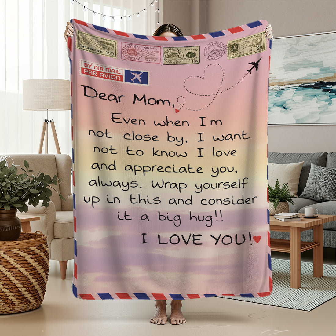Airmail-style mom blanket with loving long-distance message draped over a cozy green sofa — Discover heartfelt personal gifts at HerTender.com