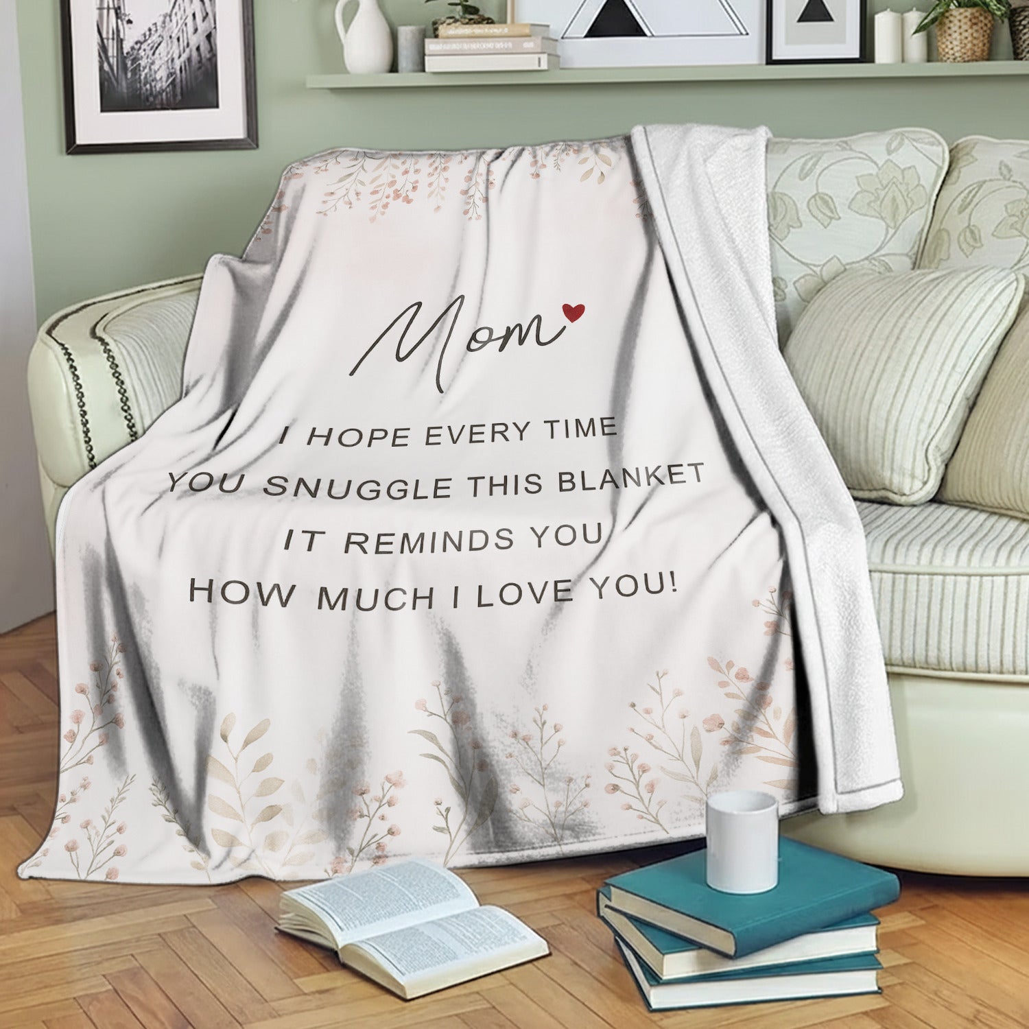 Personalized mom blanket with loving message draped over a cozy green sofa — Discover heartfelt personal gifts at HerTender.com