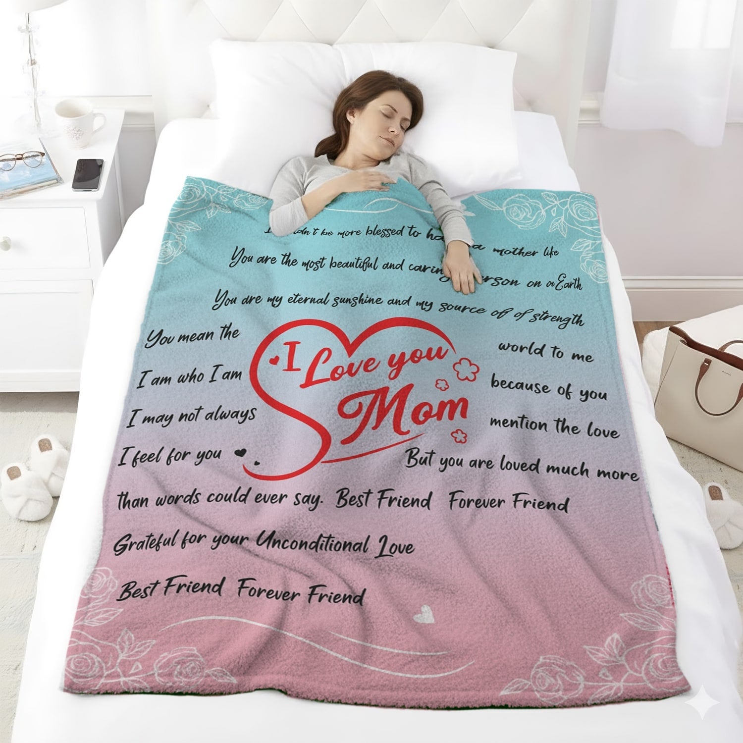 Woman sleeping under pastel pink and blue mom blanket with loving message and red heart design — Discover heartfelt personal gifts at HerTender.com