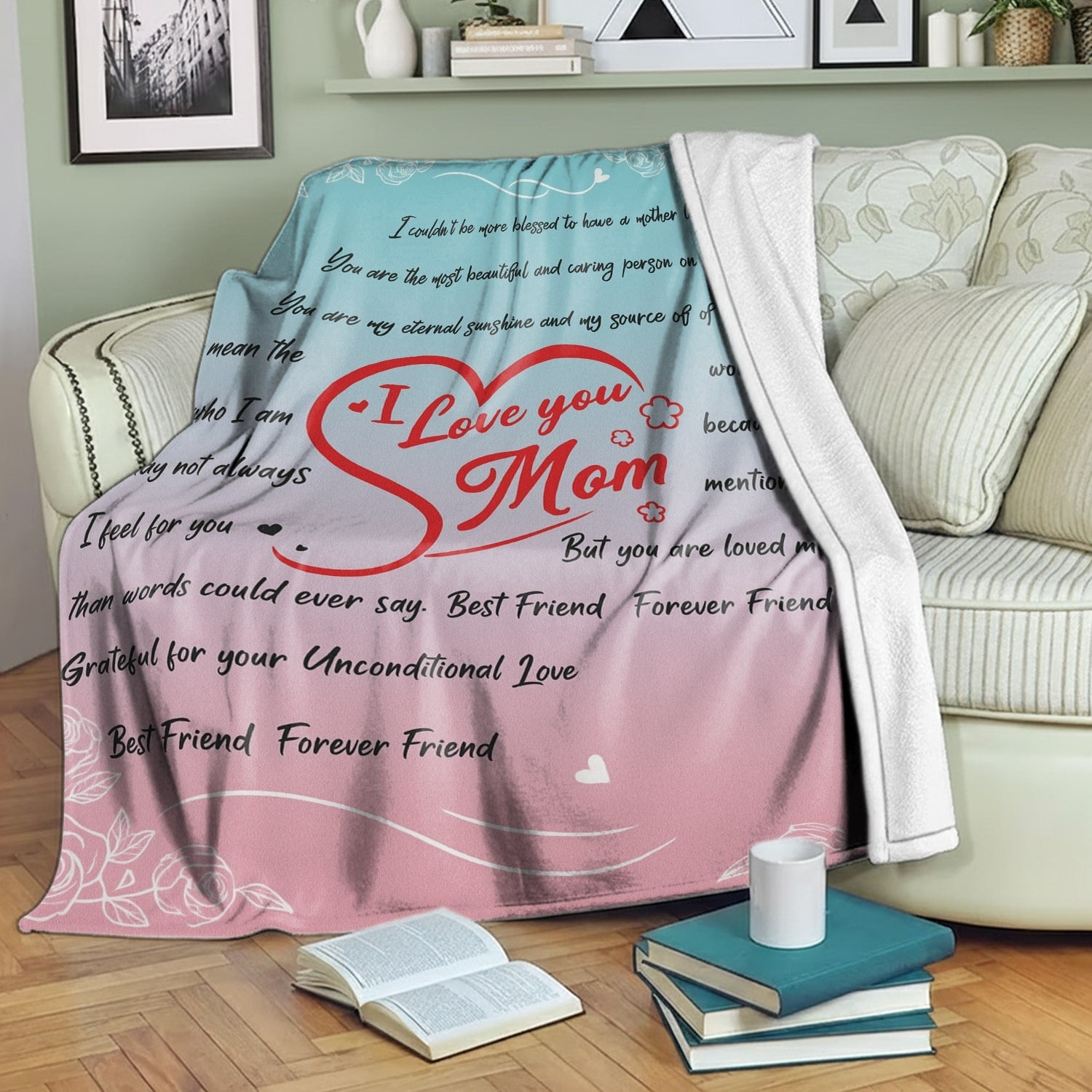Pastel pink and blue mom blanket with loving message draped over a cozy green sofa — Discover heartfelt personal gifts at HerTender.com
