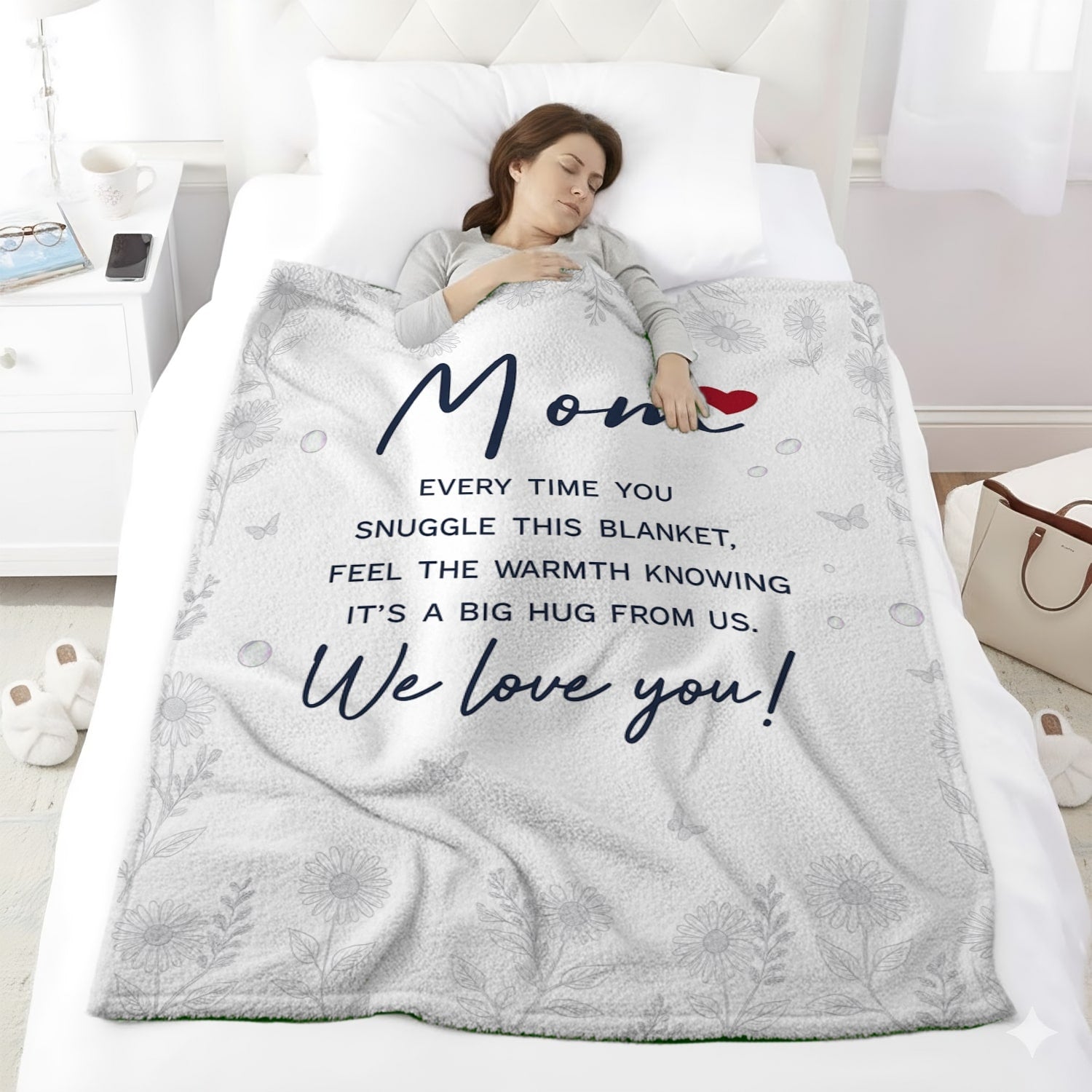 Woman sleeping under a white mom blanket with floral design and heartfelt message — Discover heartfelt personal gifts at HerTender.com