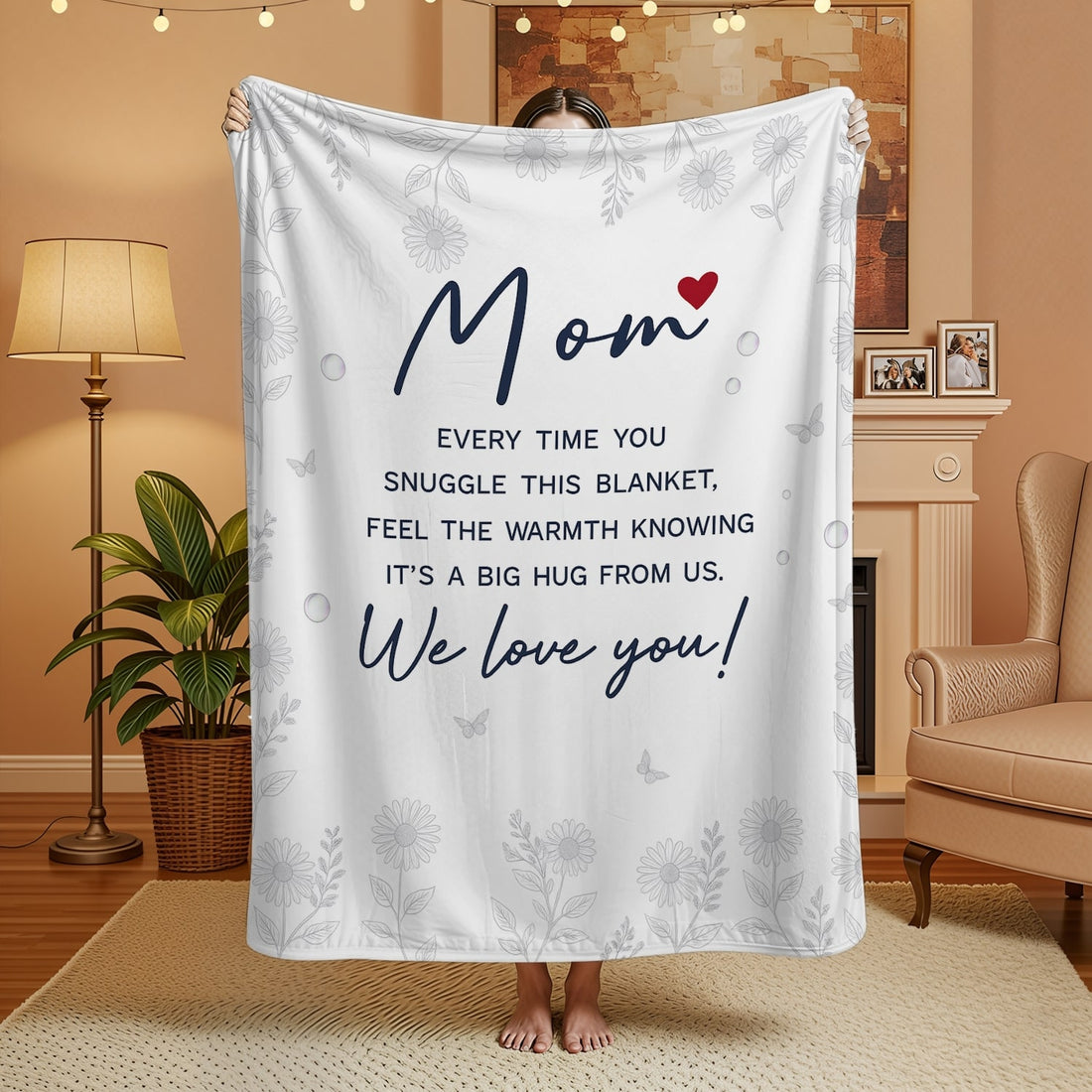 White mom blanket with floral design and heartfelt message held in a cozy living room — Discover heartfelt personal gifts at HerTender.com