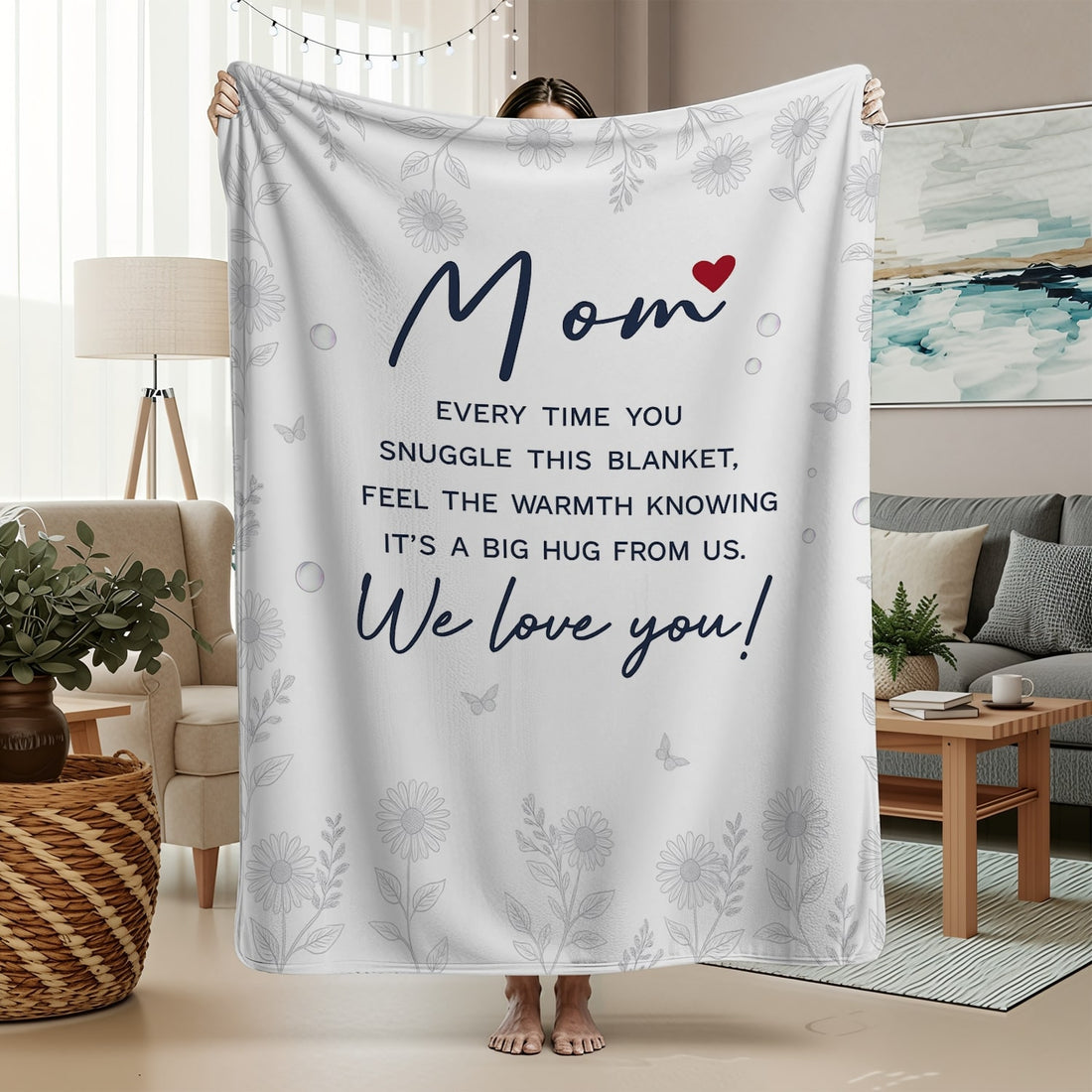 White mom blanket with floral design and heartfelt message held in a cozy living room — Discover heartfelt personal gifts at HerTender.com