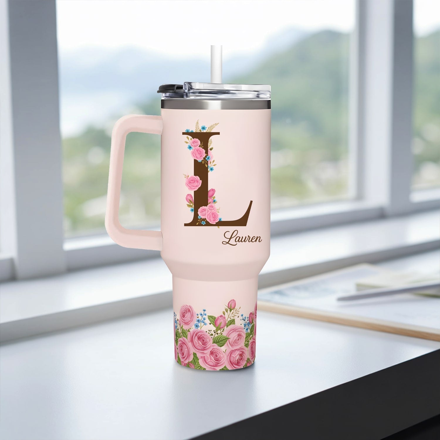 Elegant blush-pink personalized tumbler with floral letter “L” and name Lauren — a stylish and heartfelt gift from HerTender.com, perfect for coffee or tea lovers.