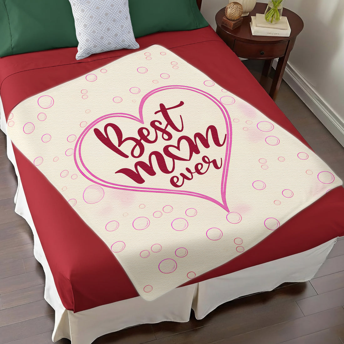 “Best Mom Ever” pink heart blanket in a cozy living room — wrap her in love with Personalized Gifts from HerTender.com.