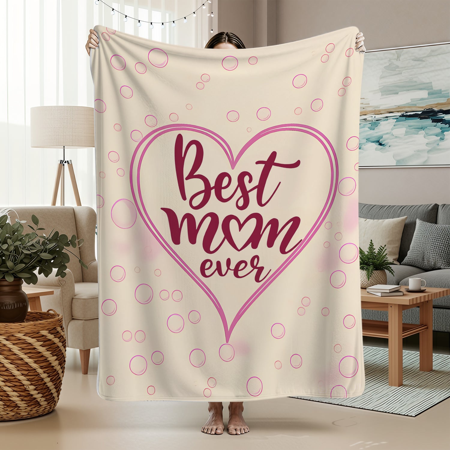 Cream and pink “Best Mom Ever” blanket in a cozy home — wrap her in love with Personalized Gifts from HerTender.com.