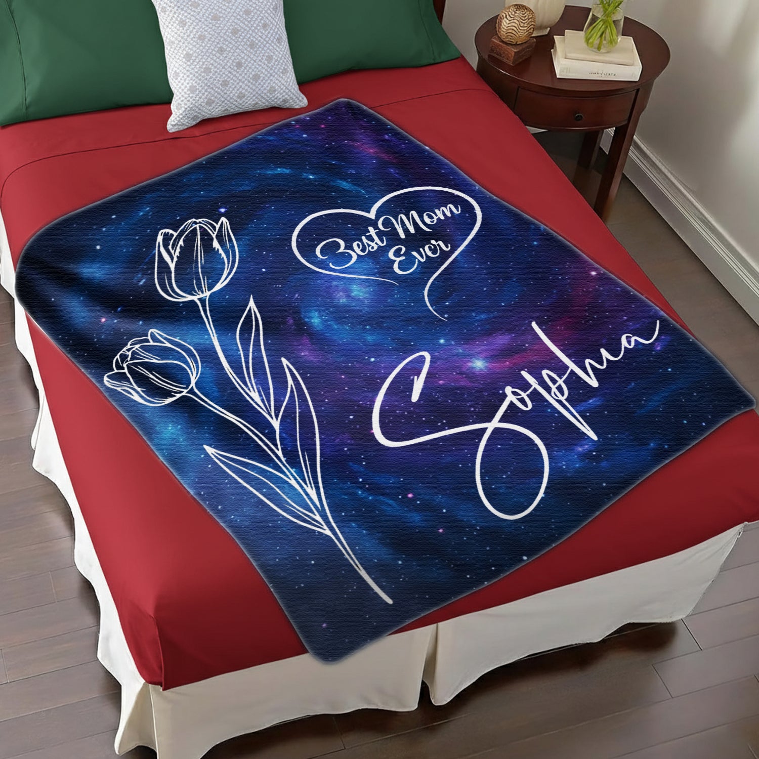 Galaxy “Best Mom Ever” personalized blanket with tulip line art and name on a cozy red bed — Find meaningful personalized gifts for moms at HerTender.com.