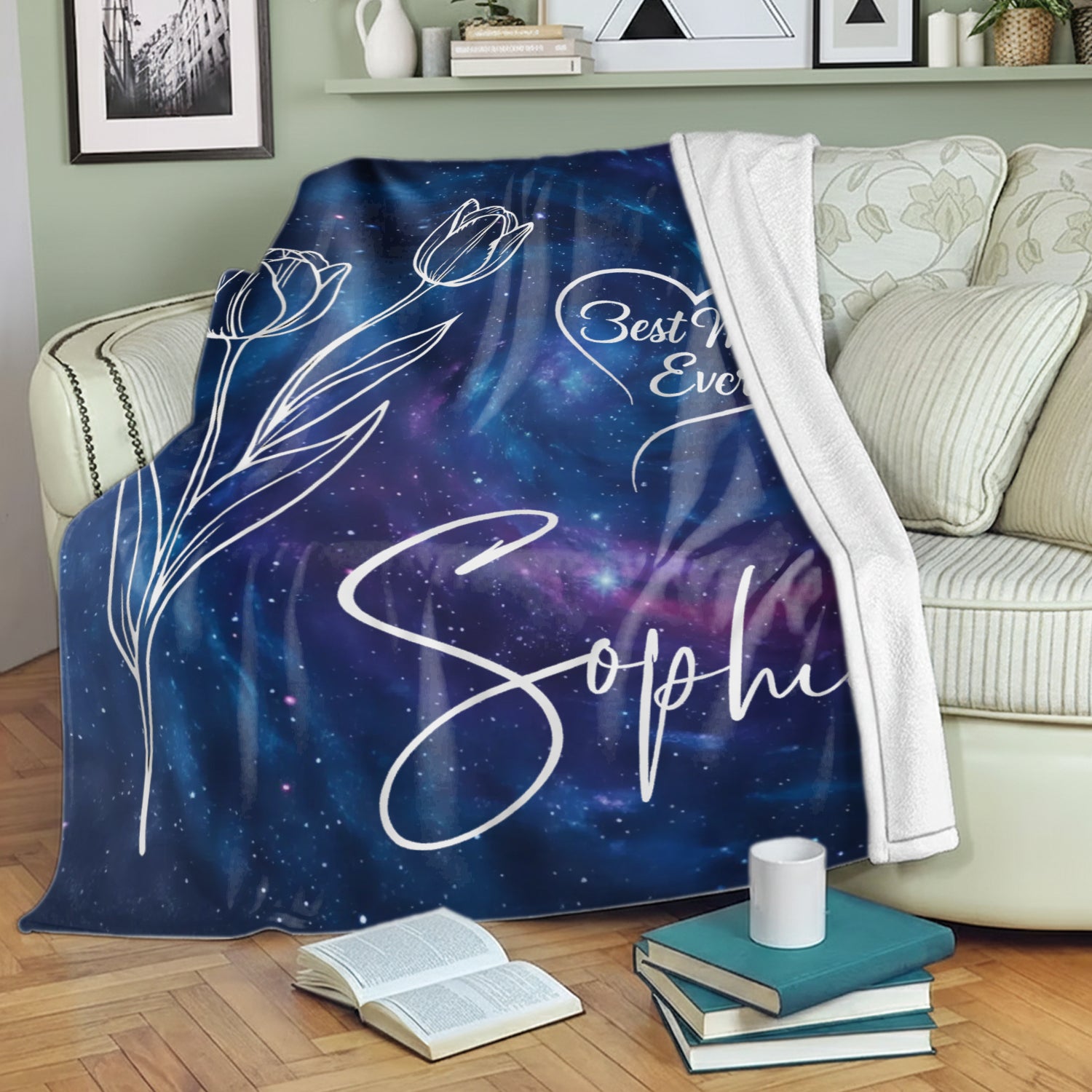 Galaxy “Best Mom Ever” personalized blanket with tulip design and name draped over a sofa — Find cozy, meaningful personalized gifts for moms at HerTender.com.