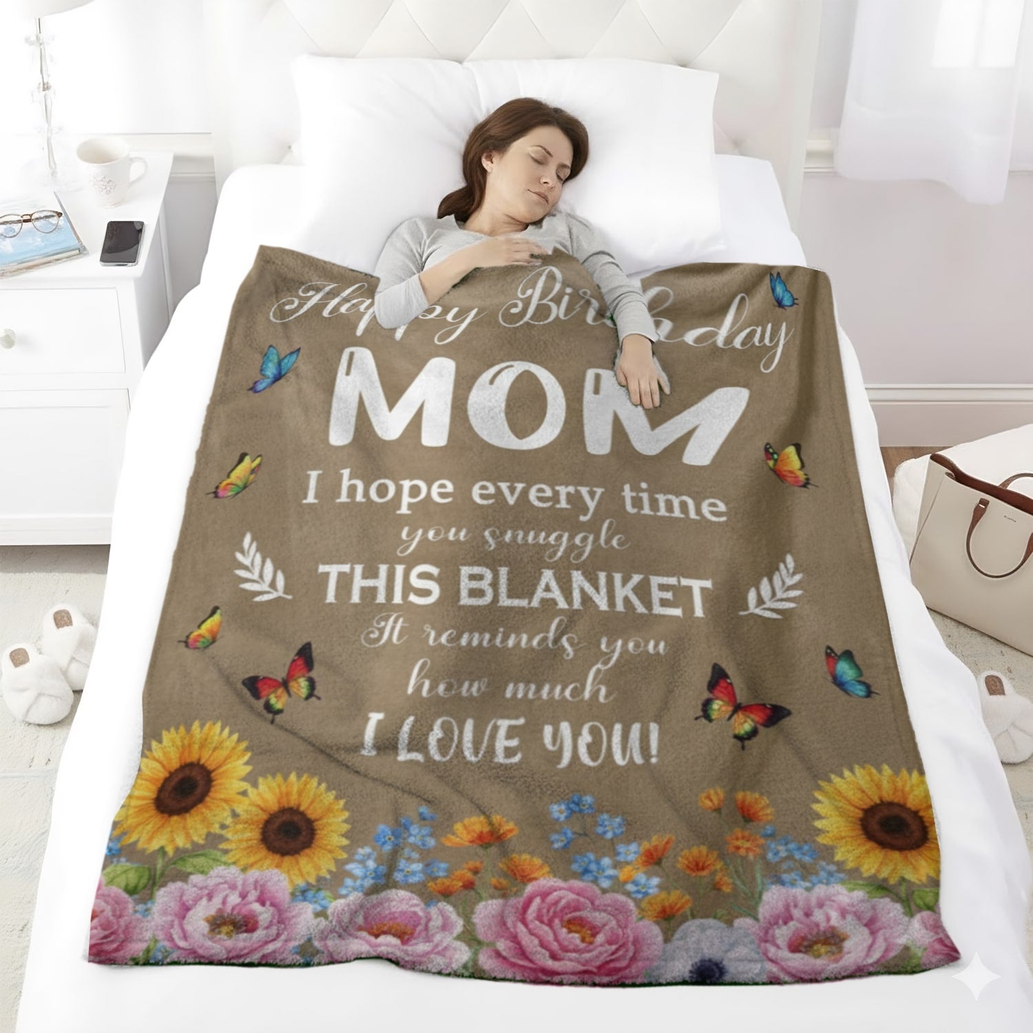 Woman sleeping under a birthday blanket for mom with flowers and butterflies, symbolizing heartfelt personalized gifts — Discover tender, meaningful personalized gifts at HerTender.com.
