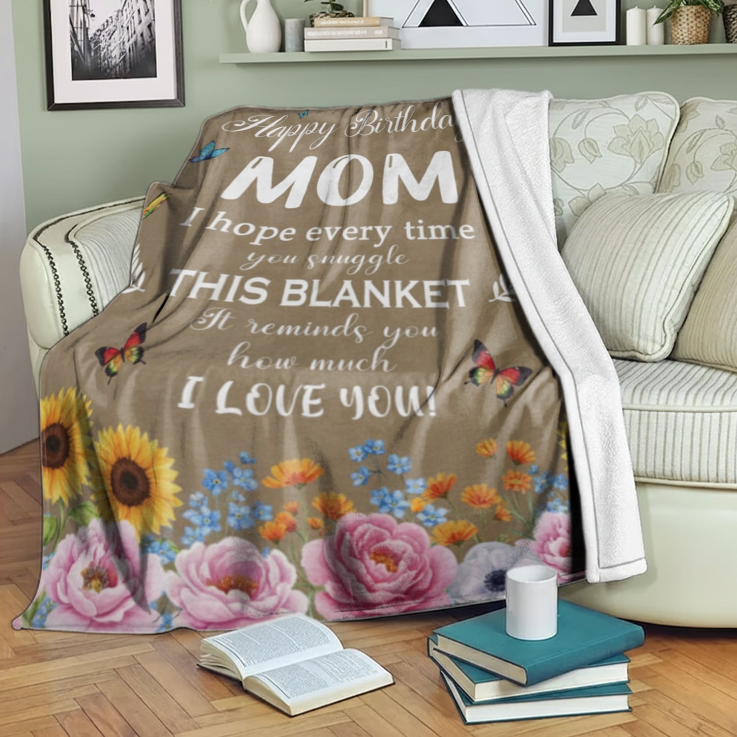 Birthday blanket for mom with flowers and butterflies draped over a cozy sofa, symbolizing personalized gifts — Discover heartfelt personalized gifts at HerTender.com.
