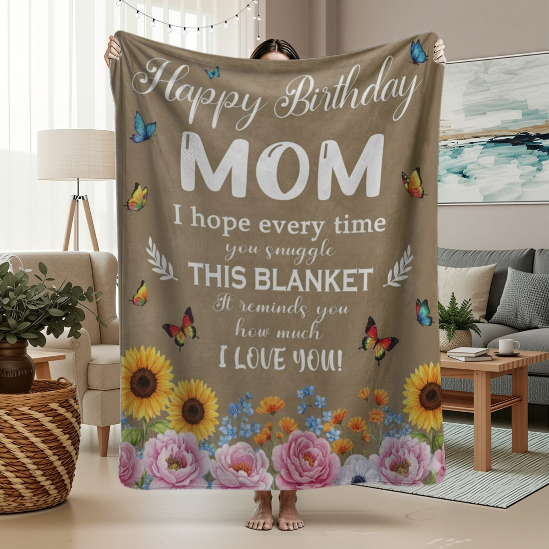 Woman holding a floral birthday blanket for mom with butterflies and heartfelt message, symbolizing personalized gifts — Discover heartfelt personalized gifts at HerTender.com.