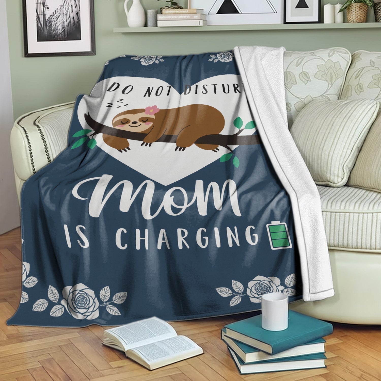 Do Not Disturb Mom Is Charging blanket with a cute sloth draped over a cozy sofa, symbolizing thoughtful personalized gifts — Discover heartfelt personalized gifts at HerTender.com.