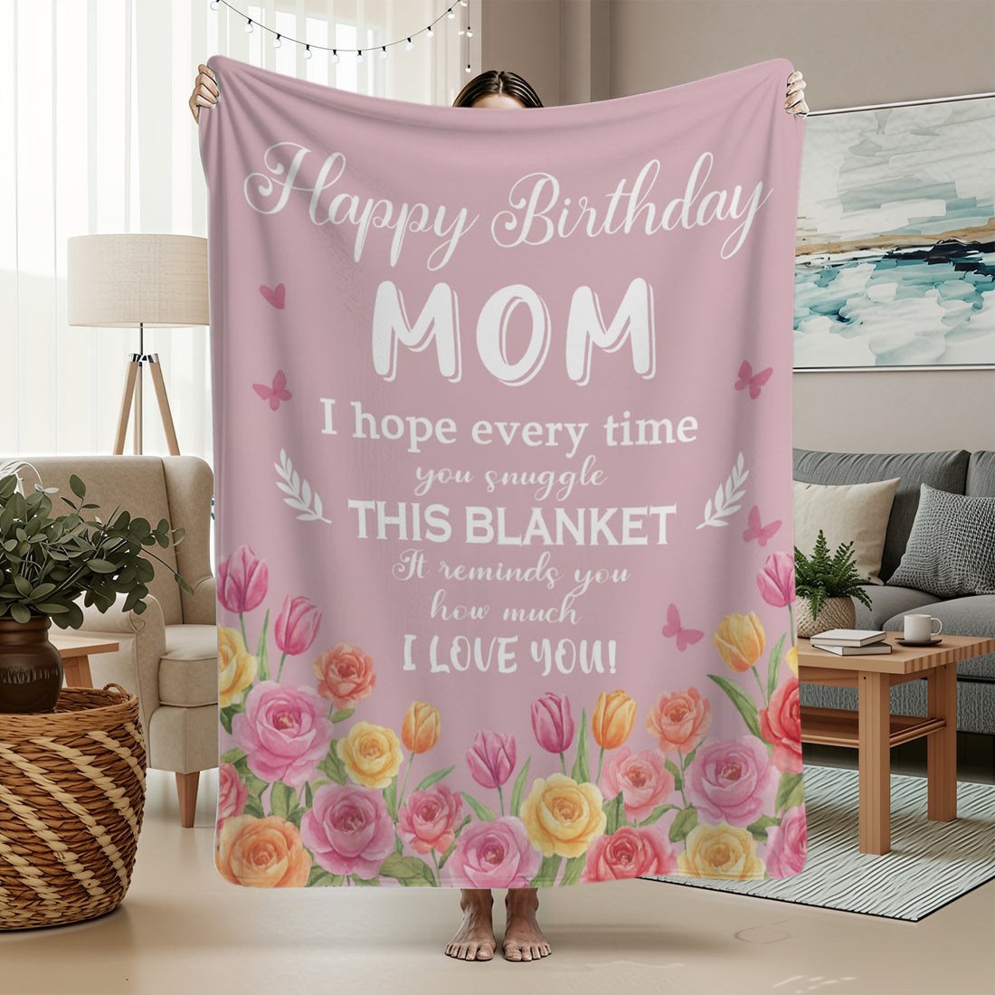 Pink floral “Happy Birthday Mom” blanket draped over a sofa — Give her the comfort of love with meaningful personalized gifts from HerTender.com.