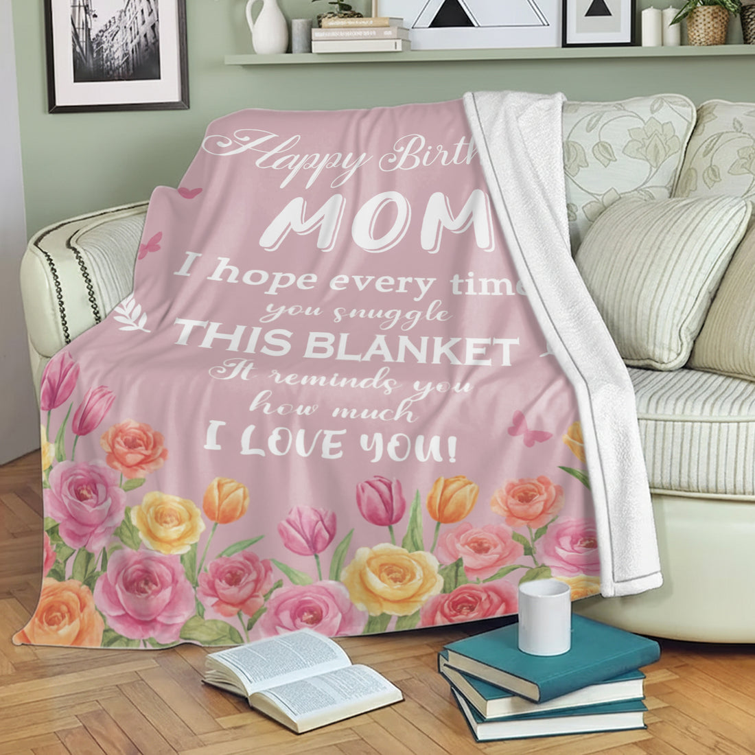 Pink floral “Happy Birthday Mom” blanket draped over a sofa — Give her the comfort of love with meaningful personalized gifts from HerTender.com.