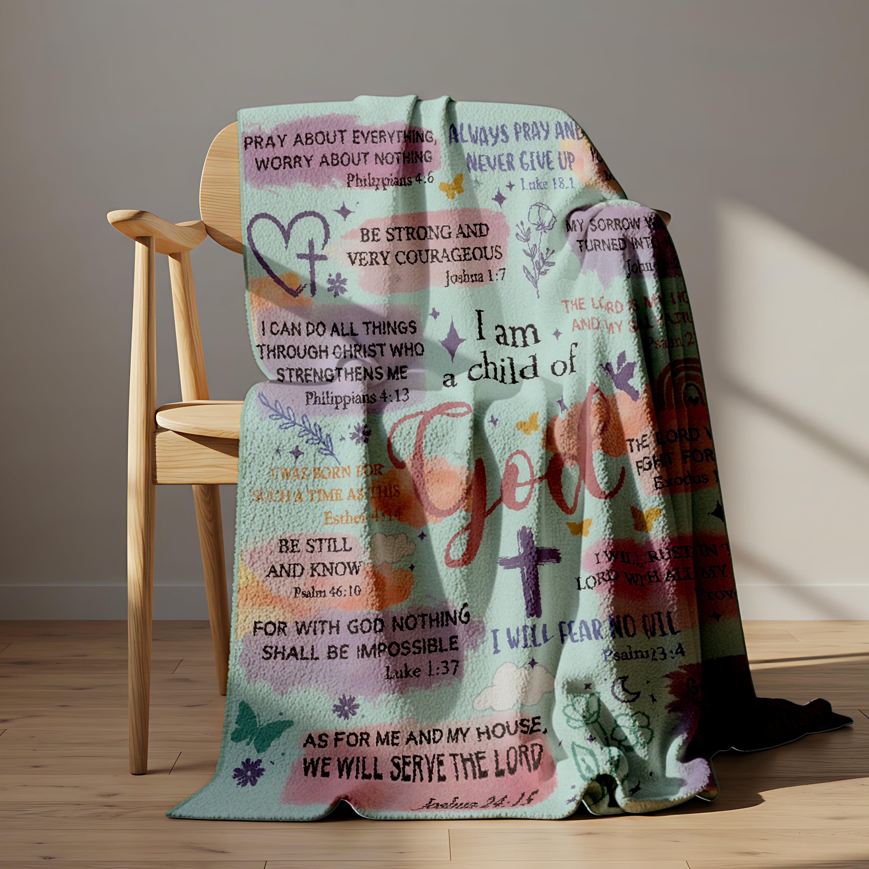 Pastel blanket with Bible verses and the phrase “I am a child of God” draped over a wooden chair in sunlight, symbolizing faith-inspired personalized gifts — Discover heartfelt personalized gifts at HerTender.com.