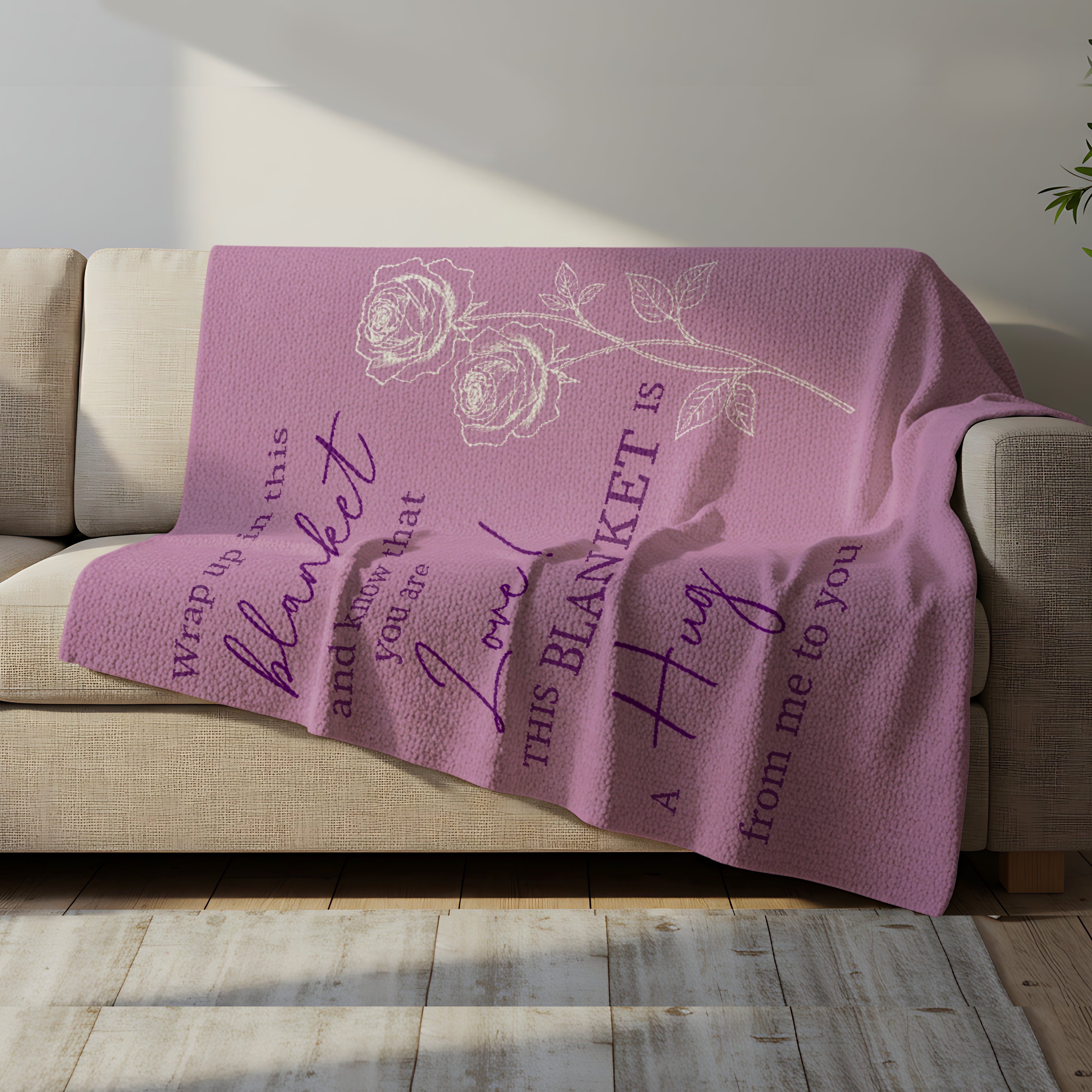Lavender blanket with rose design and the quote “This blanket is a hug from me to you” draped over a cozy sofa, symbolizing heartfelt personalized gifts — Discover meaningful personalized gifts at HerTender.com.