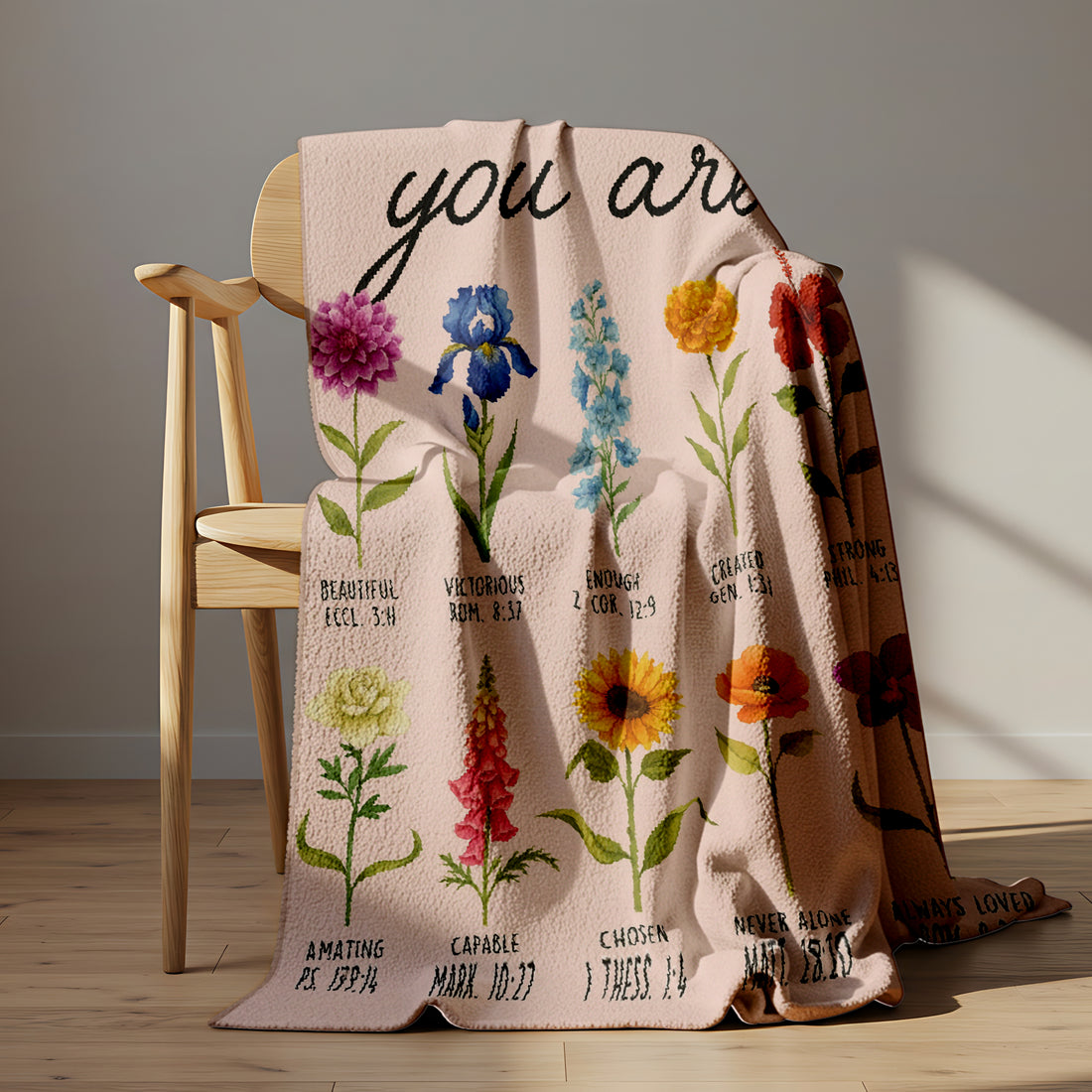 Woman holding a floral blanket with the words “You Are” and Bible verse affirmations, symbolizing faith-inspired personalized gifts — Discover heartfelt personalized gifts at HerTender.com.