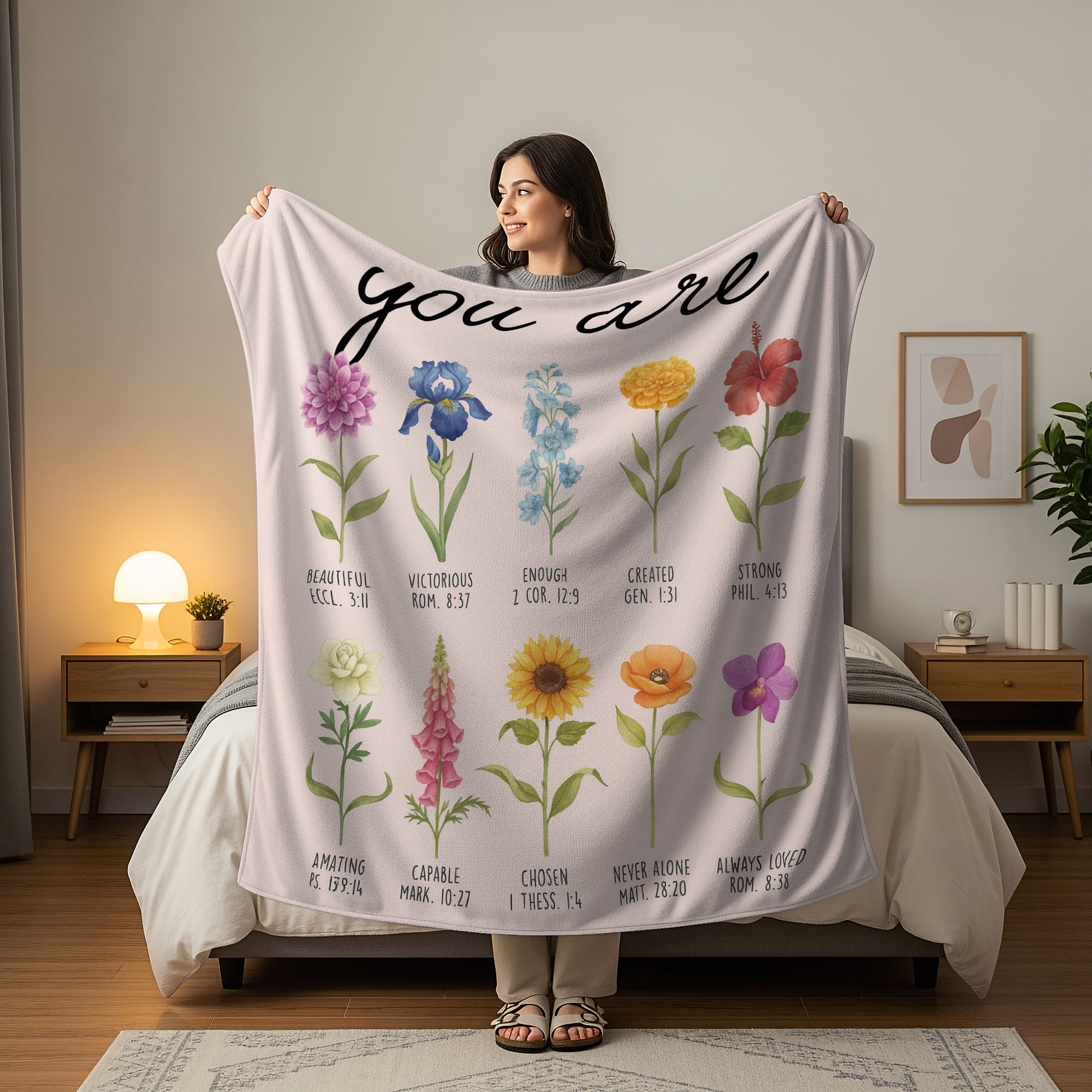 Woman holding a floral Scripture blanket with the words “You Are” and Bible verse affirmations, symbolizing faith-inspired personalized gifts — Discover heartfelt personalized gifts at HerTender.com.