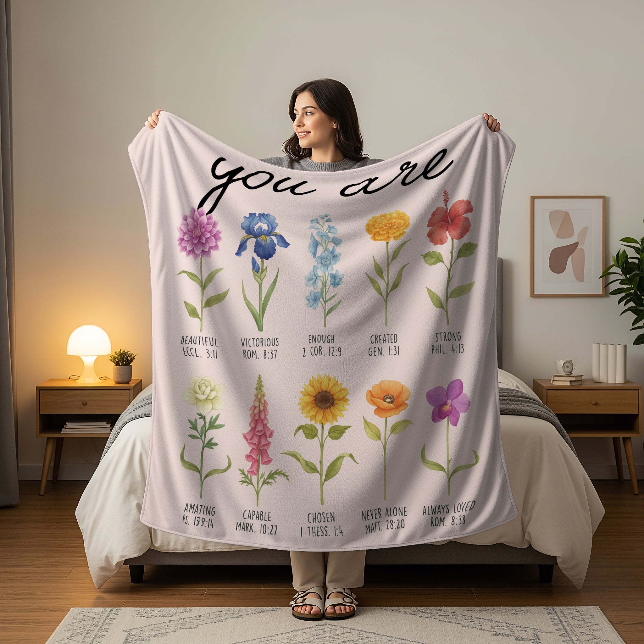 Woman holding a floral Scripture blanket with the words “You Are” and Bible verse affirmations, symbolizing faith-inspired personalized gifts — Discover heartfelt personalized gifts at HerTender.com.