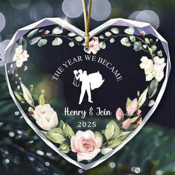 Heart-shaped personalized glass ornament with floral design and bride-and-groom silhouette for couples — Celebrate your love story with elegant personalized gifts from Hertender.com.