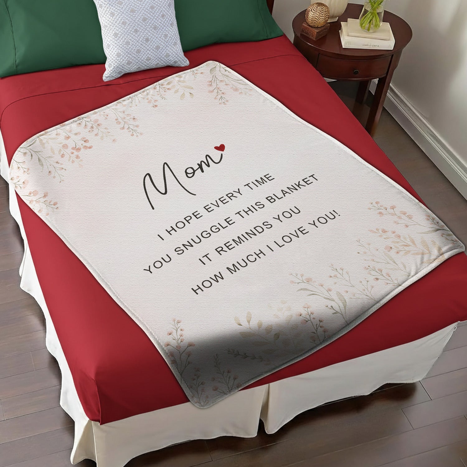 Personalized mom blanket with loving message displayed on a cozy red and white bed — Discover heartfelt personal gifts at HerTender.com.