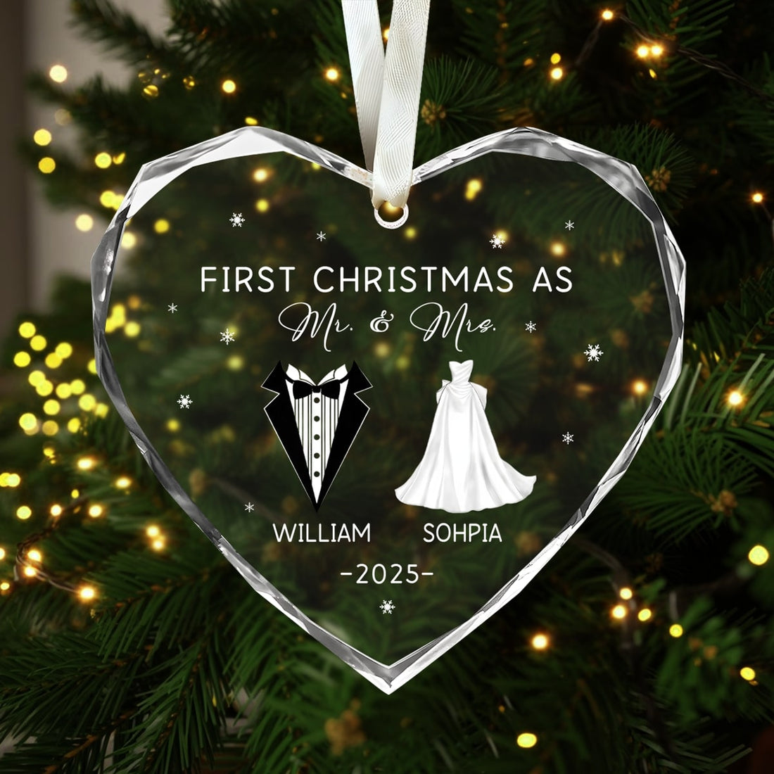 Heart-shaped glass ornament engraved “First Christmas as Mr. & Mrs.” hanging on a lit Christmas tree — Explore heartfelt personalized Christmas gifts at Hertender.com.