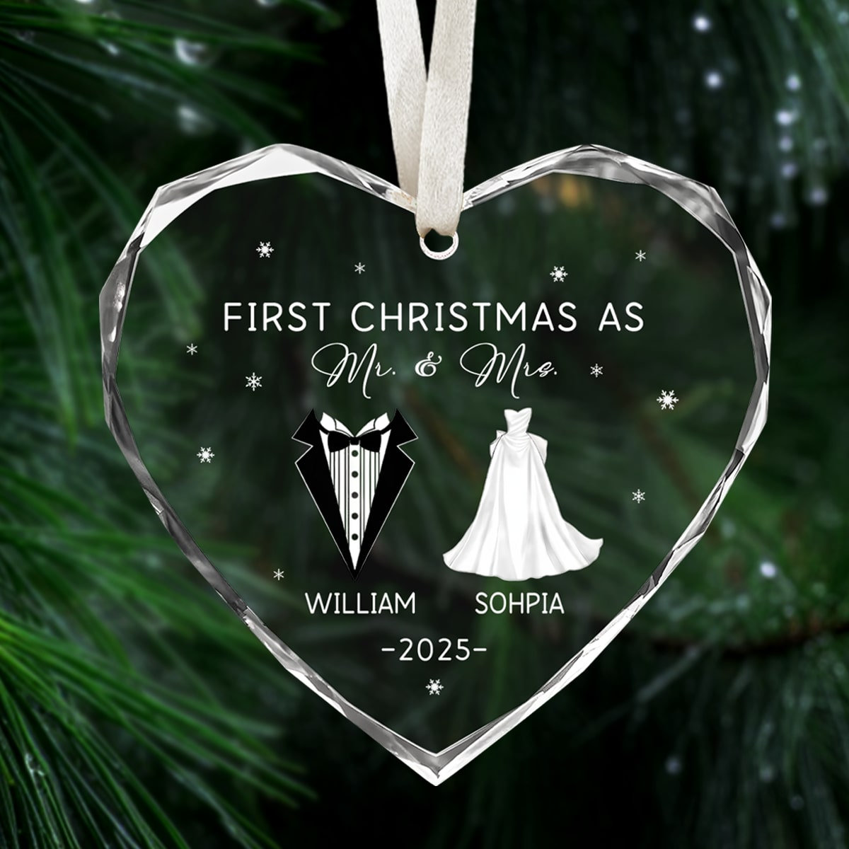 Heart-shaped glass ornament engraved “First Christmas as Mr. & Mrs.” hanging on a lush Christmas tree branch — Celebrate love with personalized Christmas gifts from Hertender.com.