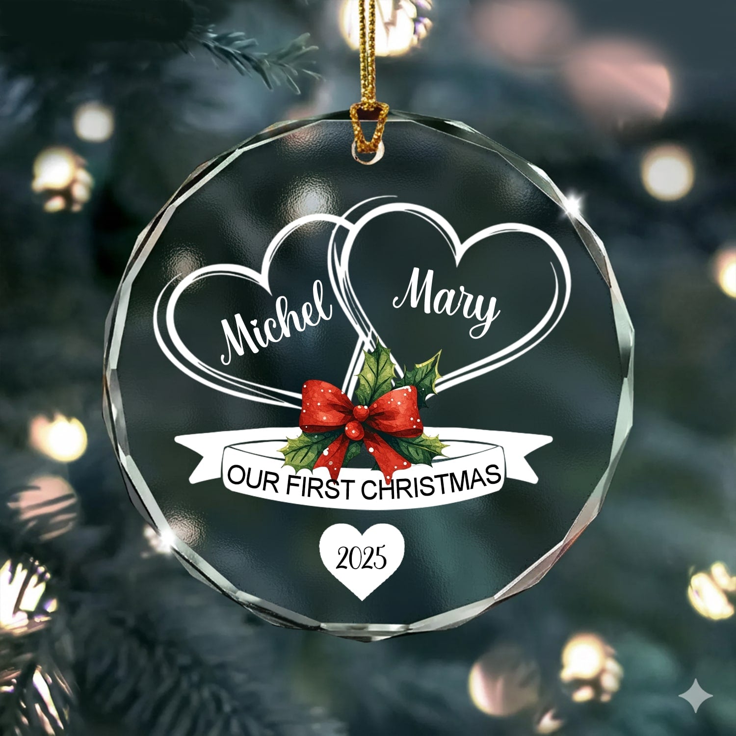 Round glass ornament engraved with two hearts and red bow reading “Our First Christmas 2025” hanging on a Christmas tree — Discover heartfelt personalized Christmas gifts at Hertender.com.