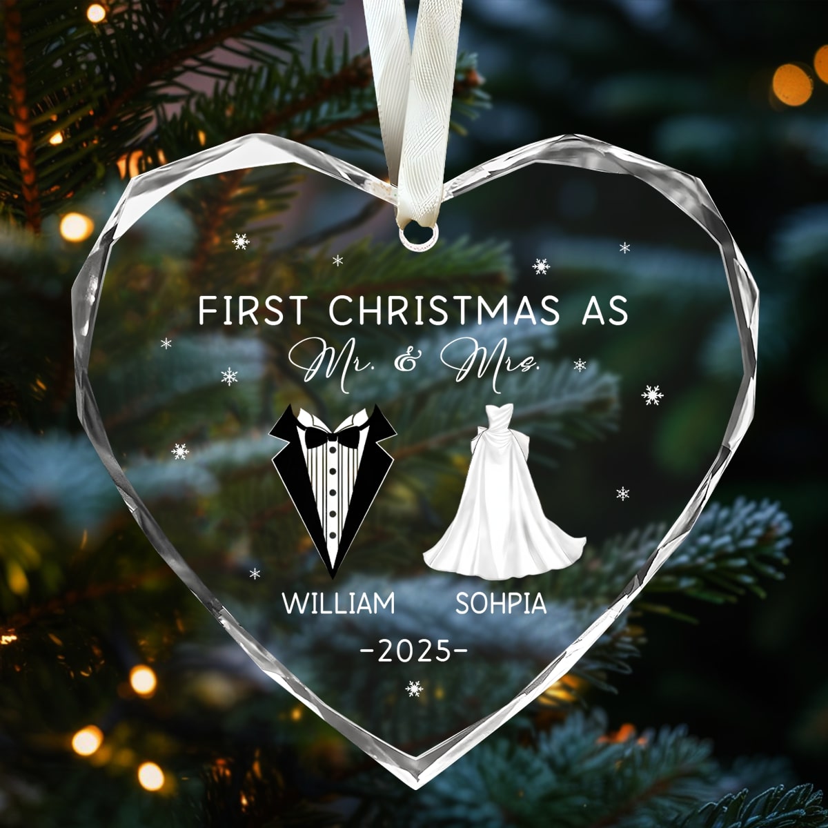Heart-shaped glass ornament engraved “First Christmas as Mr. & Mrs.” hanging on a lit Christmas tree — Explore heartfelt personalized Christmas gifts at Hertender.com.