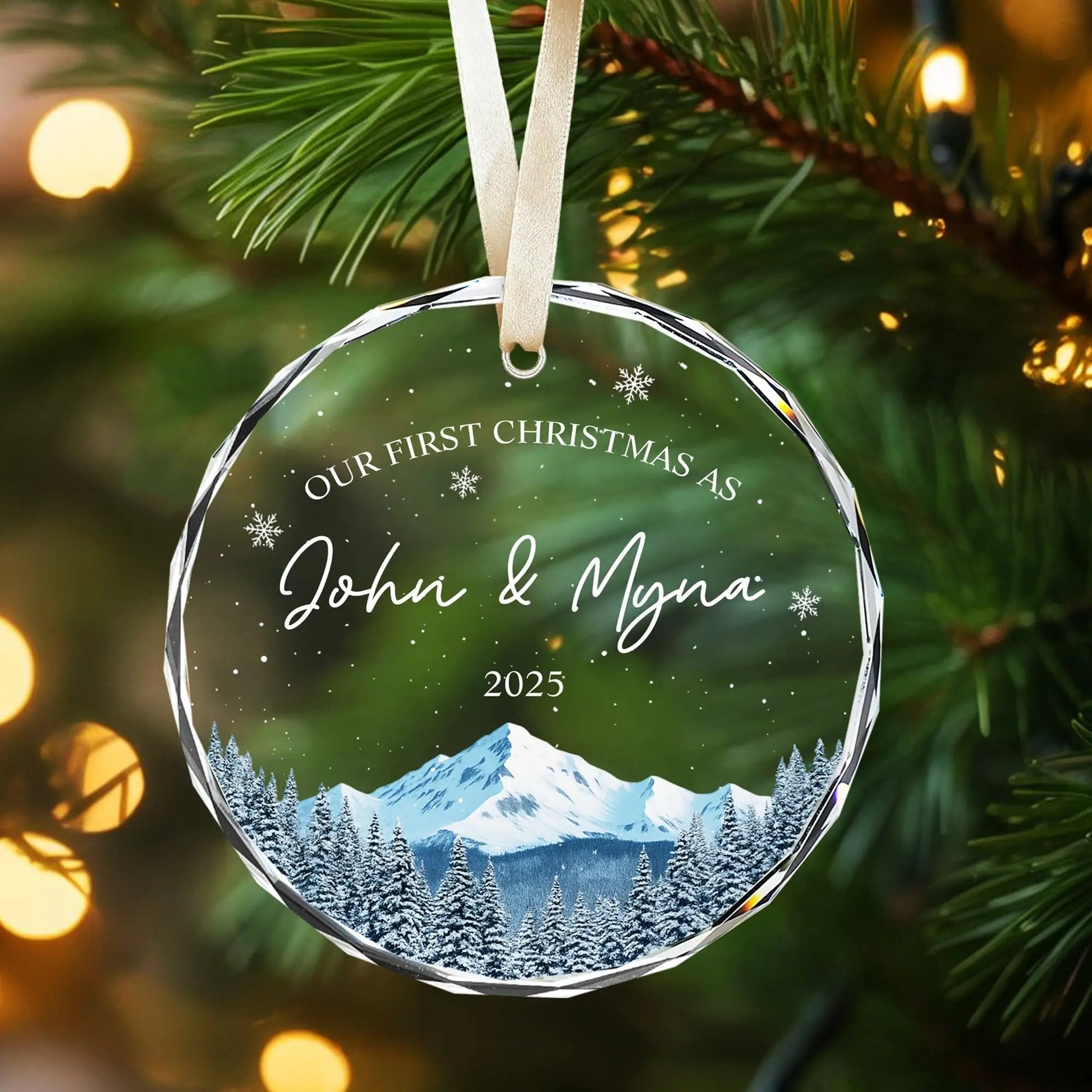 Personalized glass ornament for couples featuring snowy mountain design and soft Christmas lights — Explore meaningful personalized gifts at HerTender.com, where love is beautifully celebrated.