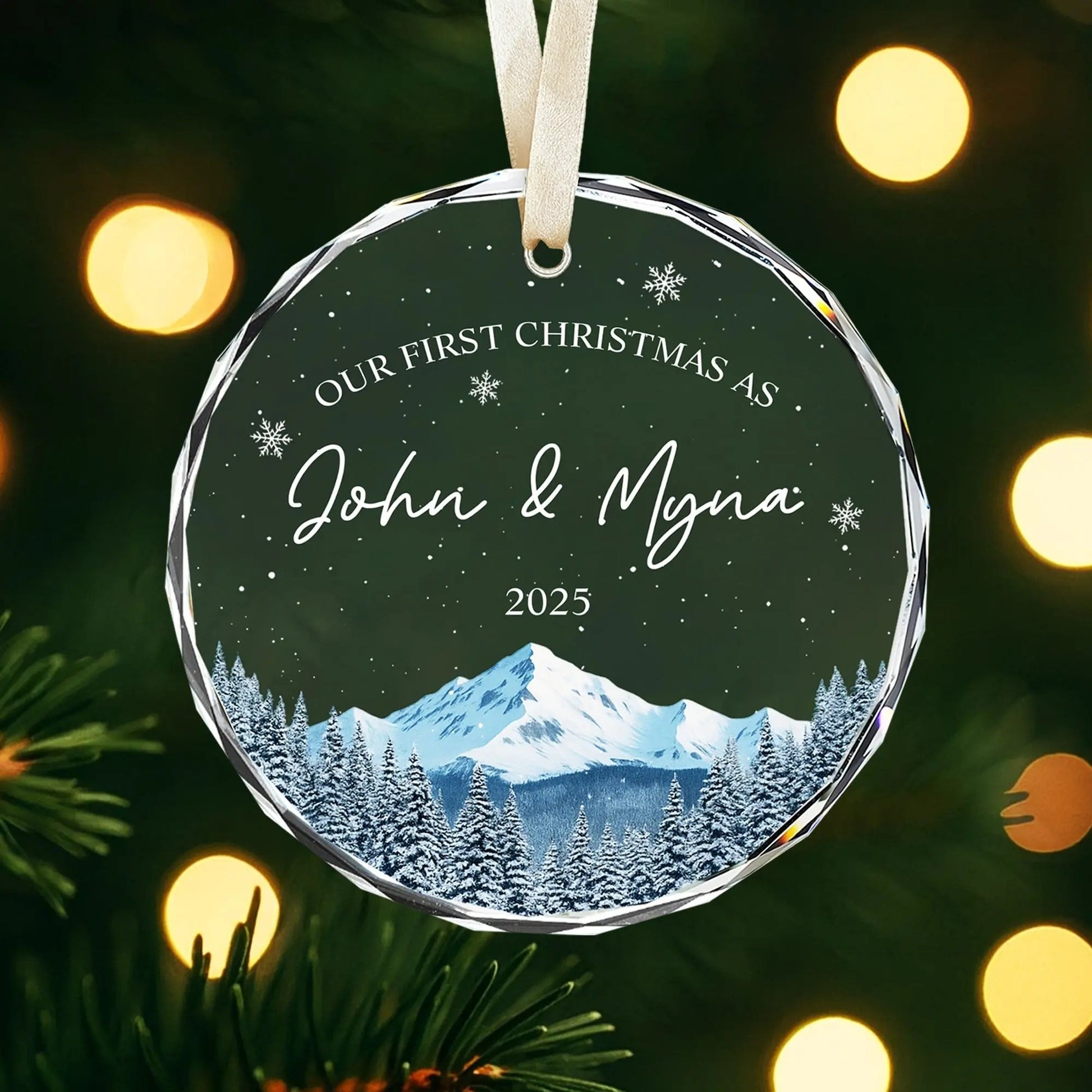 Personalized glass ornament for couples with snowy mountain design and warm Christmas lights — Discover meaningful personalized gifts at HerTender.com, crafted to celebrate your love story.