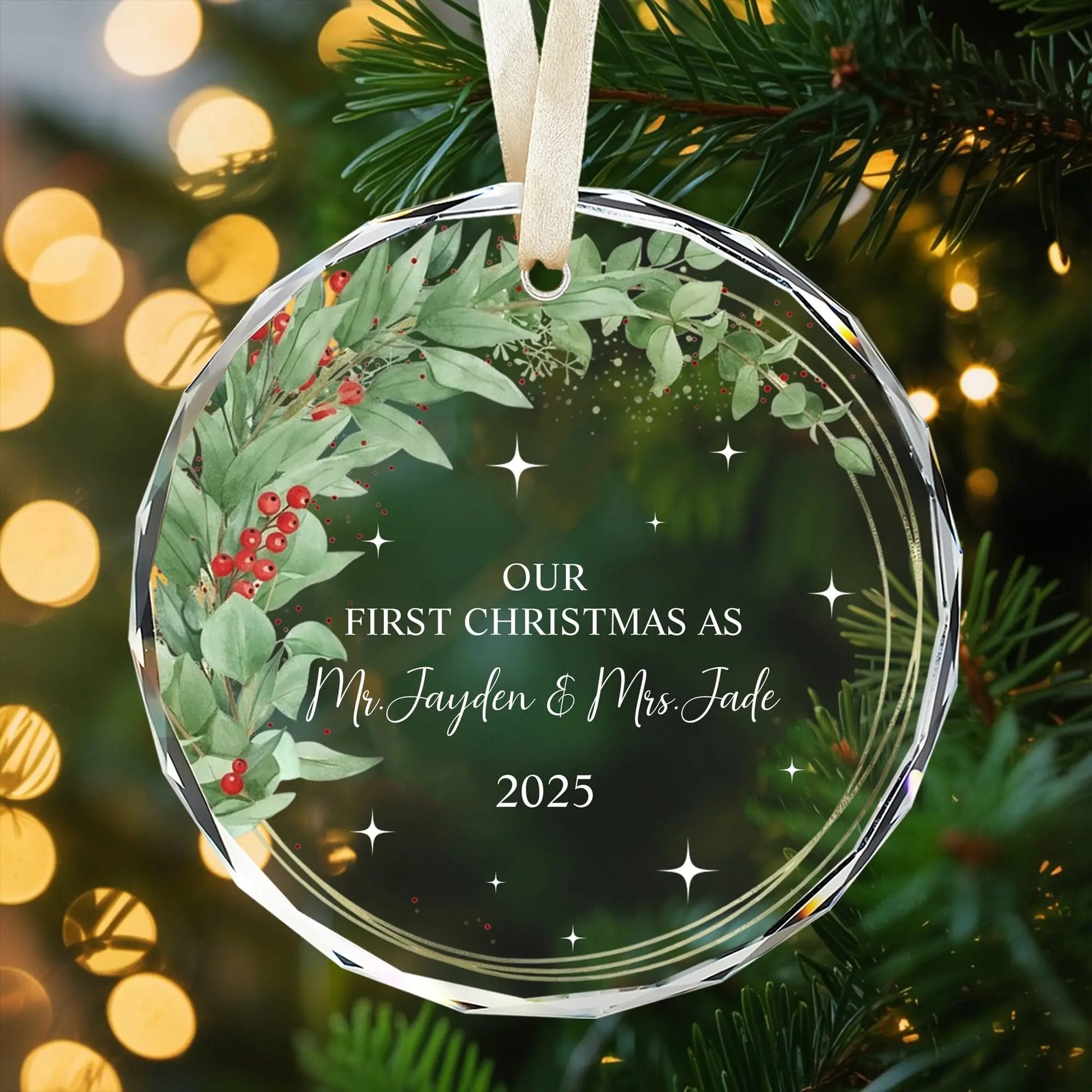 Personalized glass ornament with greenery and red berry wreath design for newlyweds’ first Christmas 2025 — Celebrate your love with meaningful personalized gifts from Hertender.com.