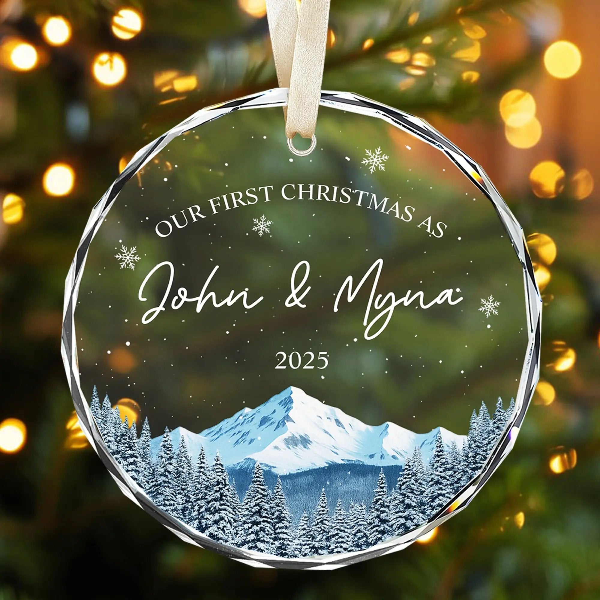 Personalized glass Christmas ornament for couples with snowy mountain design and glowing holiday lights — Celebrate love this season with meaningful personalized gifts from HerTender.com.