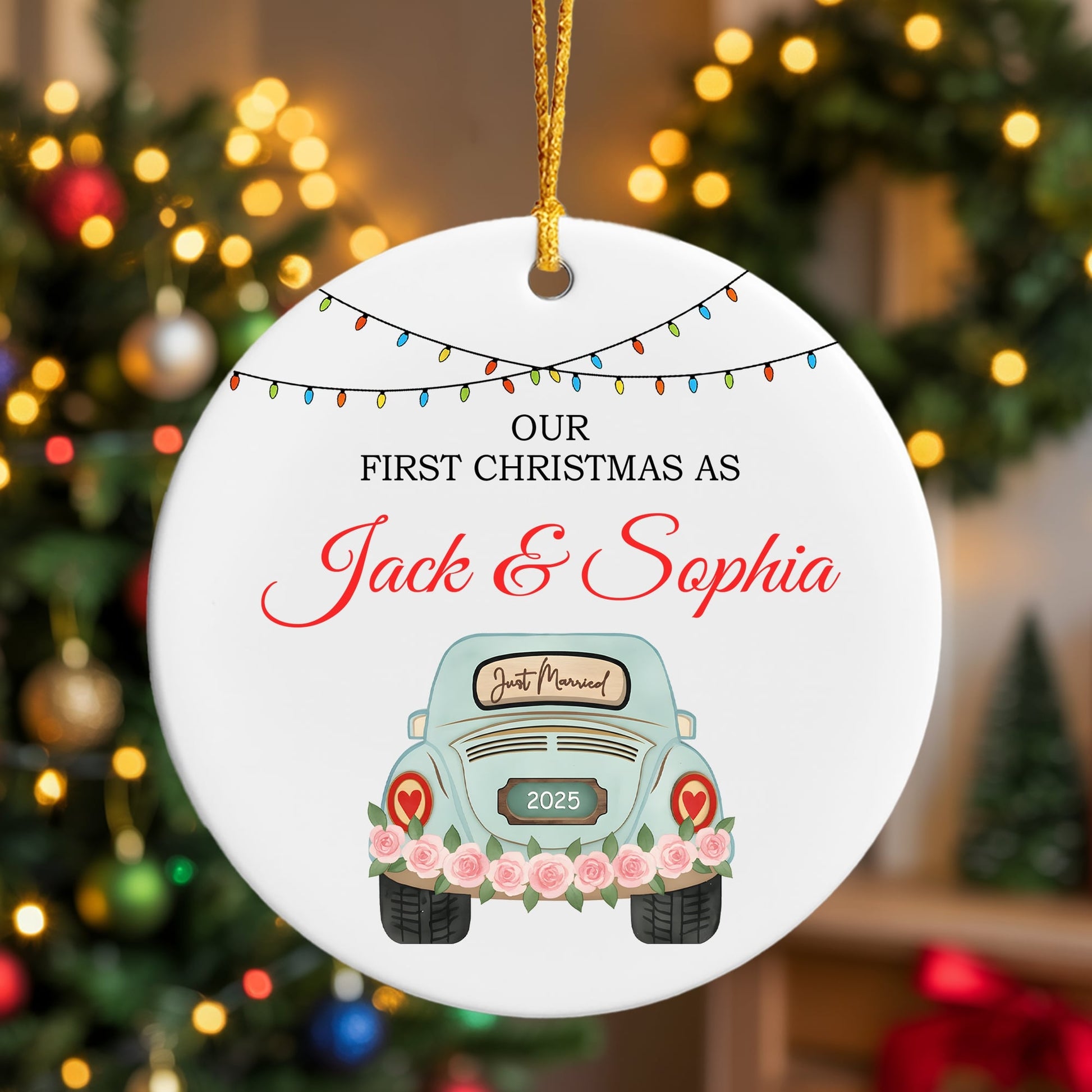 “Our First Christmas As Jack & Sophia” ceramic ornament featuring a pastel blue car with roses, hanging in front of a Christmas tree. Celebrate your love story with tender personalized gifts from Hertender at Hertender.com.