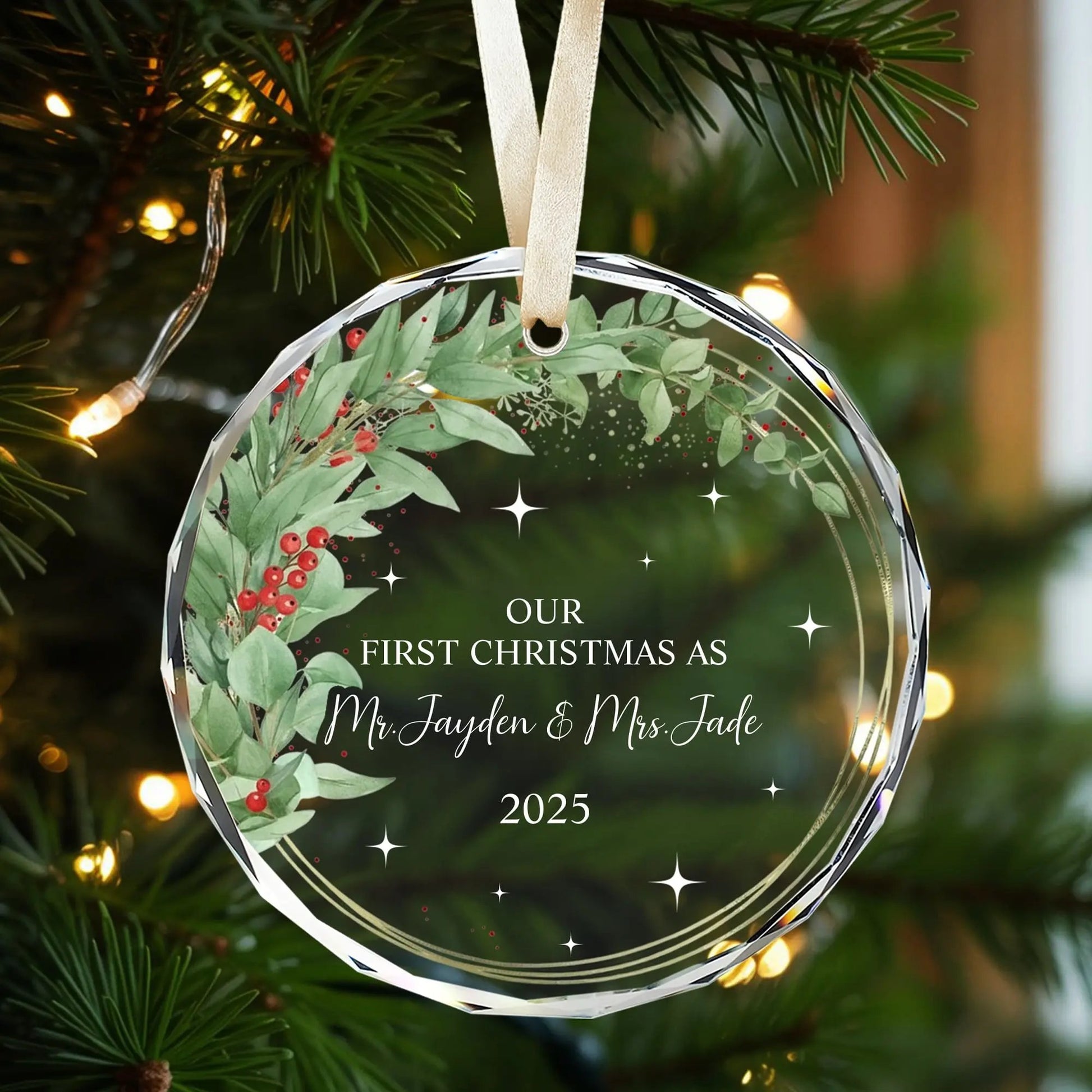 Personalized glass ornament with greenery and red berry wreath design for newlyweds’ first Christmas — Discover elegant personalized gifts that celebrate love at Hertender.com.