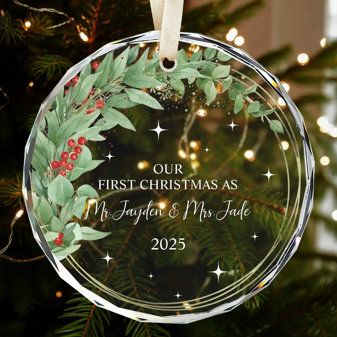 Personalized glass Christmas ornament with greenery wreath and red berries for newlyweds’ first Christmas — Discover meaningful personalized gifts that celebrate love at Hertender.com.