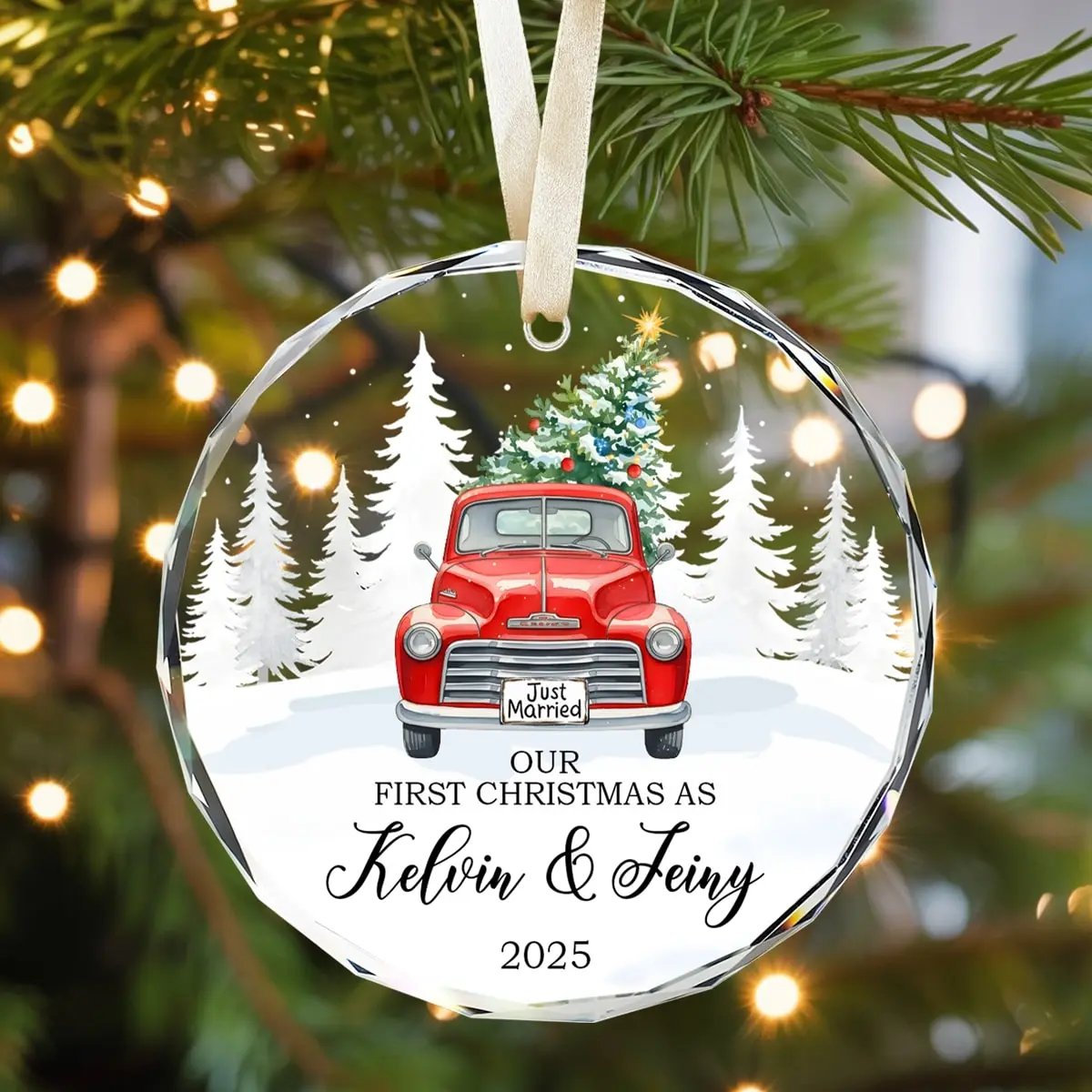 Round personalized glass ornament with red vintage truck and Christmas tree, featuring “Our First Christmas As Kelvin and Jeiny 2025” — a romantic keepsake for newlyweds, available at Hertender.com.