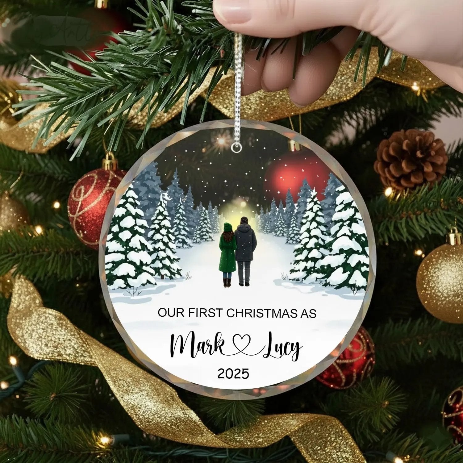 Round personalized glass ornament featuring a winter couple design and text “Our First Christmas As Mark and Lucy 2025” — Create a heartfelt keepsake of your love story with personalized gifts from Hertender.com.