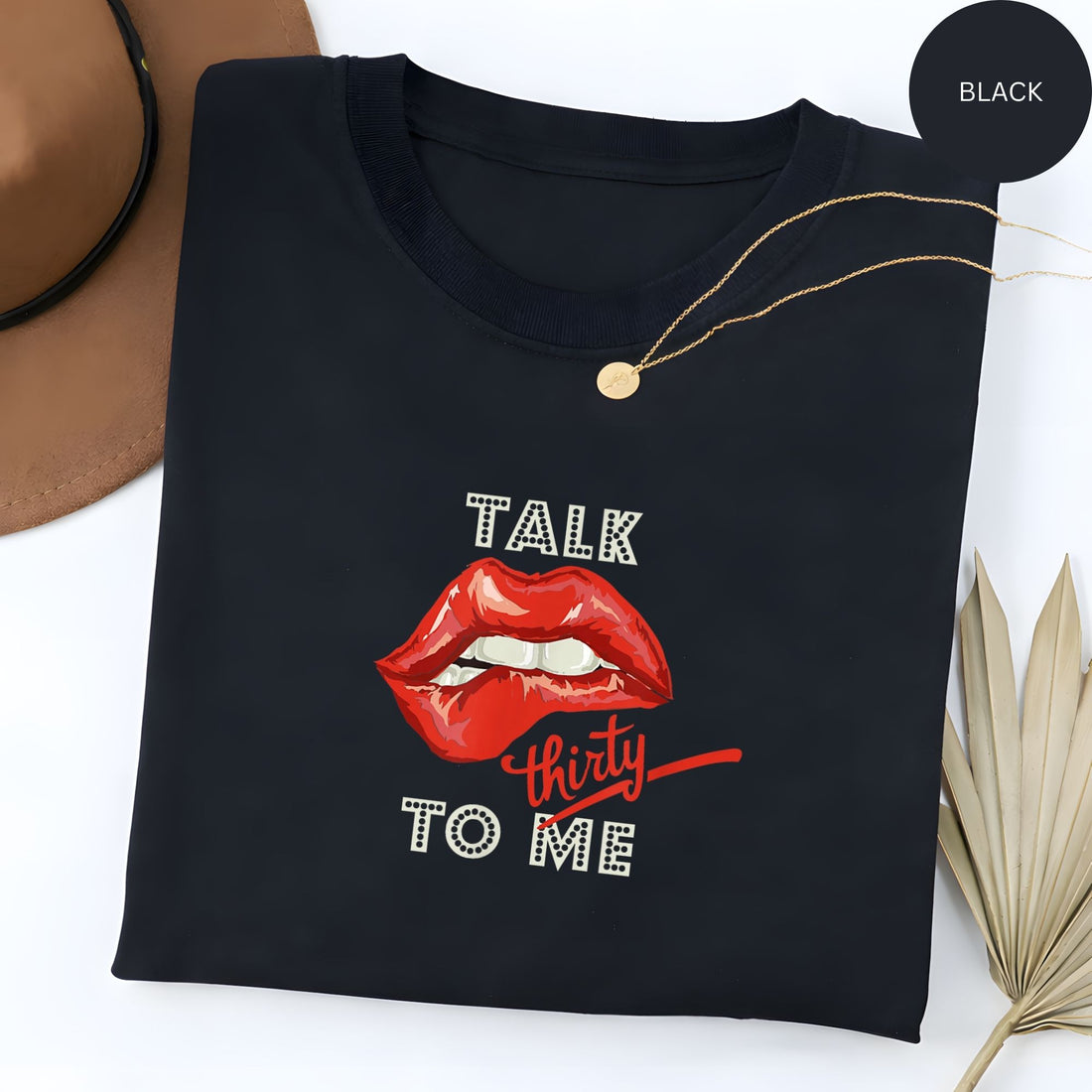 Black “TALK thirty TO ME” tee with red lips graphic and red script. Shop Hertender at hertender.com.